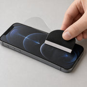 Apple iPhone 12 Pro Matte hydrogel screen protector – flexible anti-glare film being fitted with the supplied squeegee